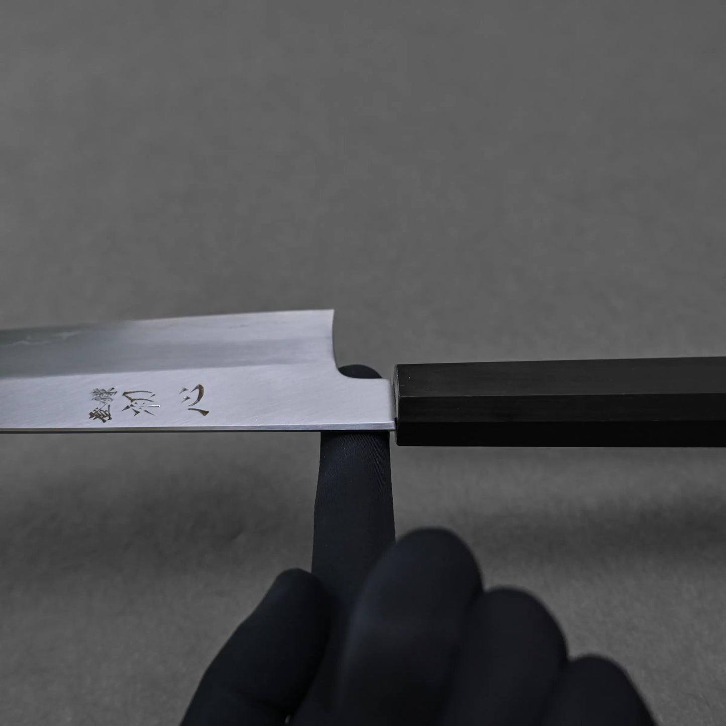 Balance point of a gyuto chef knife which is shown around the neck of the knife