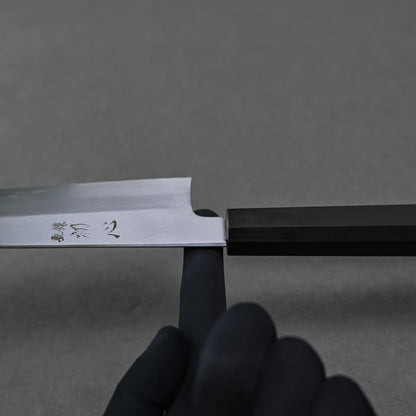 Balance point of a gyuto chef knife which is shown around the neck of the knife