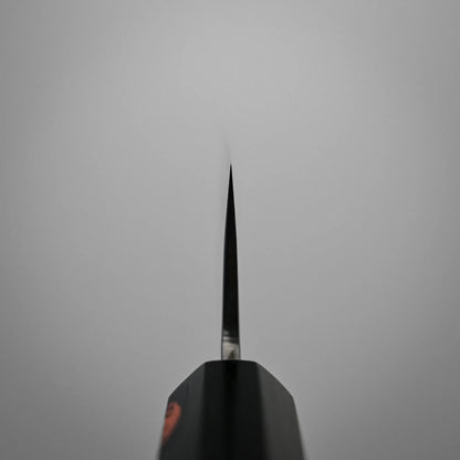 Choil shot of a kasumi Japanese chef's knife blade photographed from above against a plain gray background.