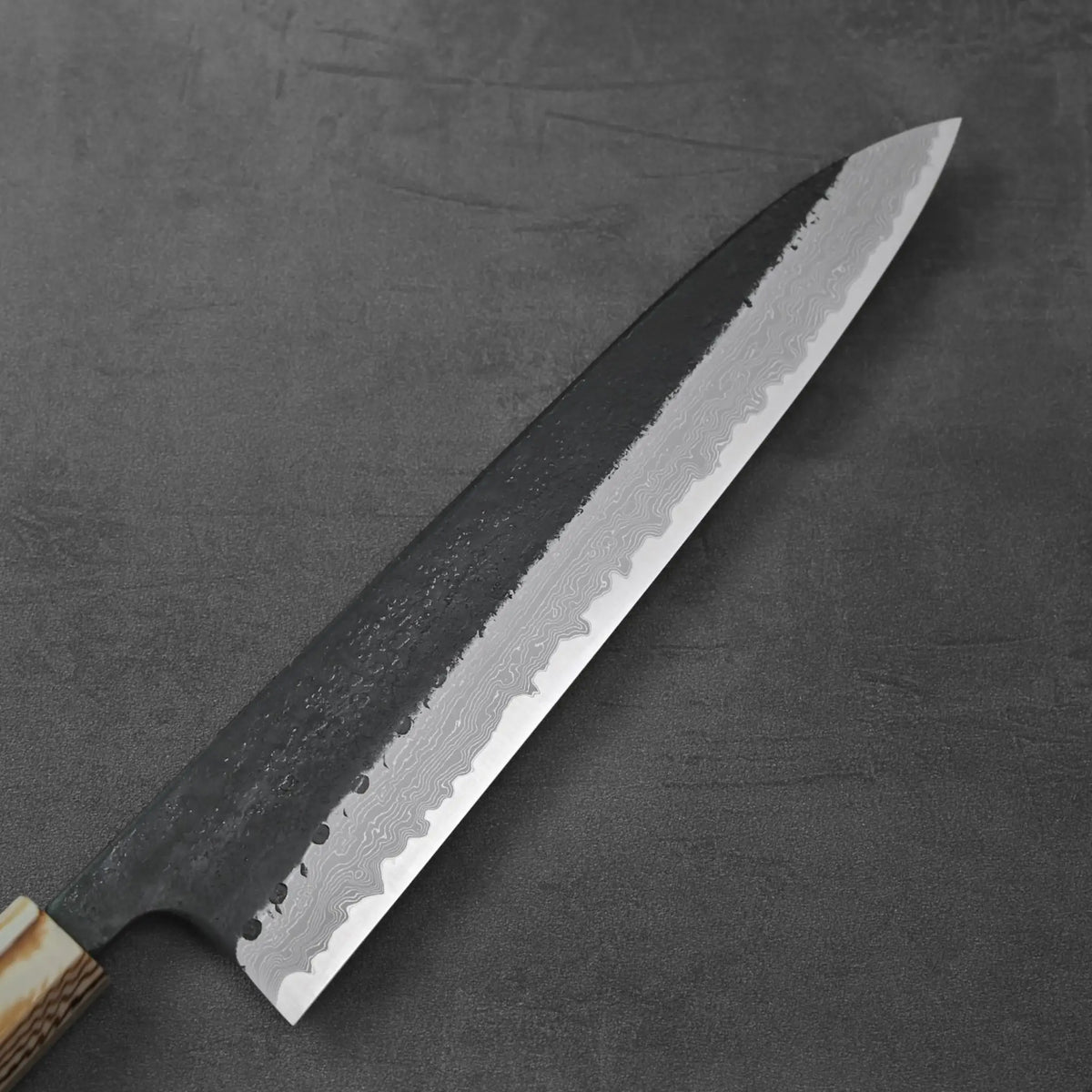 A gyuto with a wooden handle featuring smooth contours and subtle grain patterns.