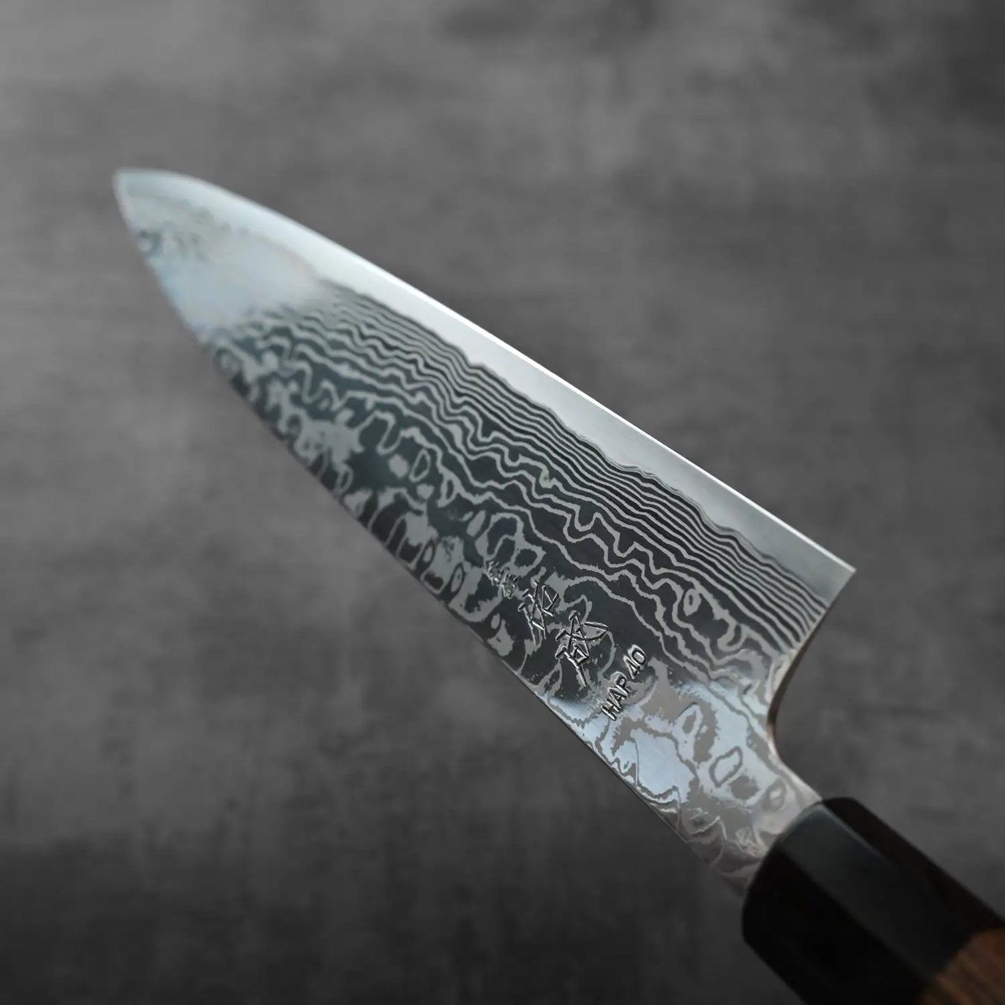 Close-up of a gyuto featuring a distinctive patterned blade.