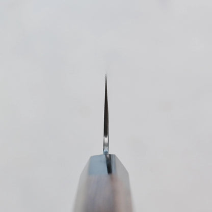 Close-up view of the tip of a gyuto, captured from the point facing directly toward the camera.