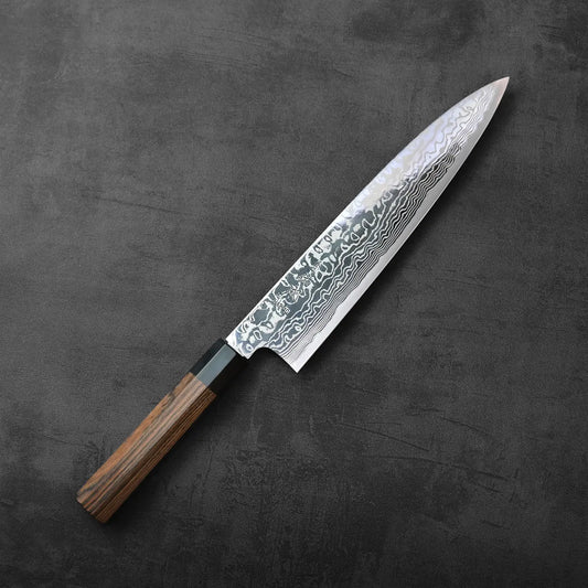 Gyuto with a patterned damascus blade and a wooden handle, showing length and distinctive texture.