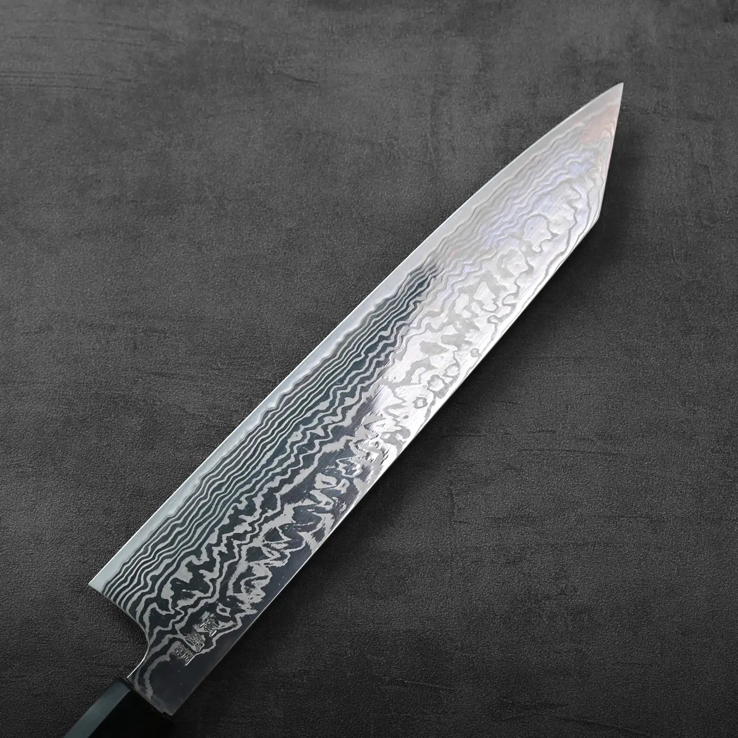 Kiritsuke gyuto with a damascus pattern and 270mm blade displayed. Detailed lines visible on steel.