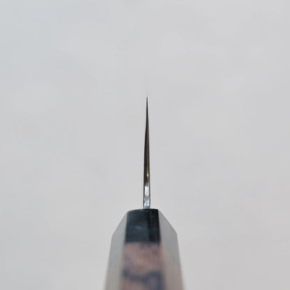 Close-up of a kiritsuke gyuto blade showing its damascus steel pattern and 270mm length.