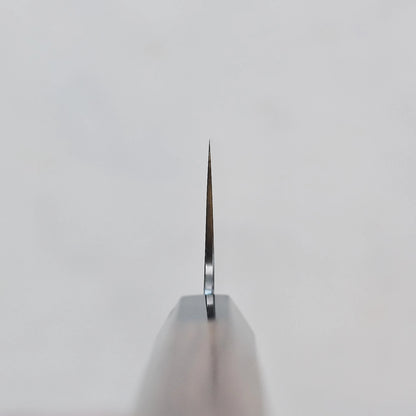 Close-up of the thin edge of a gyuto, emphasizing its slim blade and polished surface.