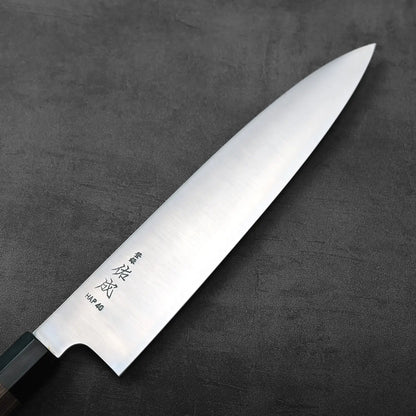 Gyuto with a silver blade and black handle, highlighting the contrast between the polished steel and grip.