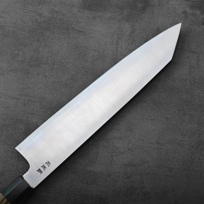 A kiritsuke gyuto with a 270mm blade is resting, displaying its profile and cutting edge.