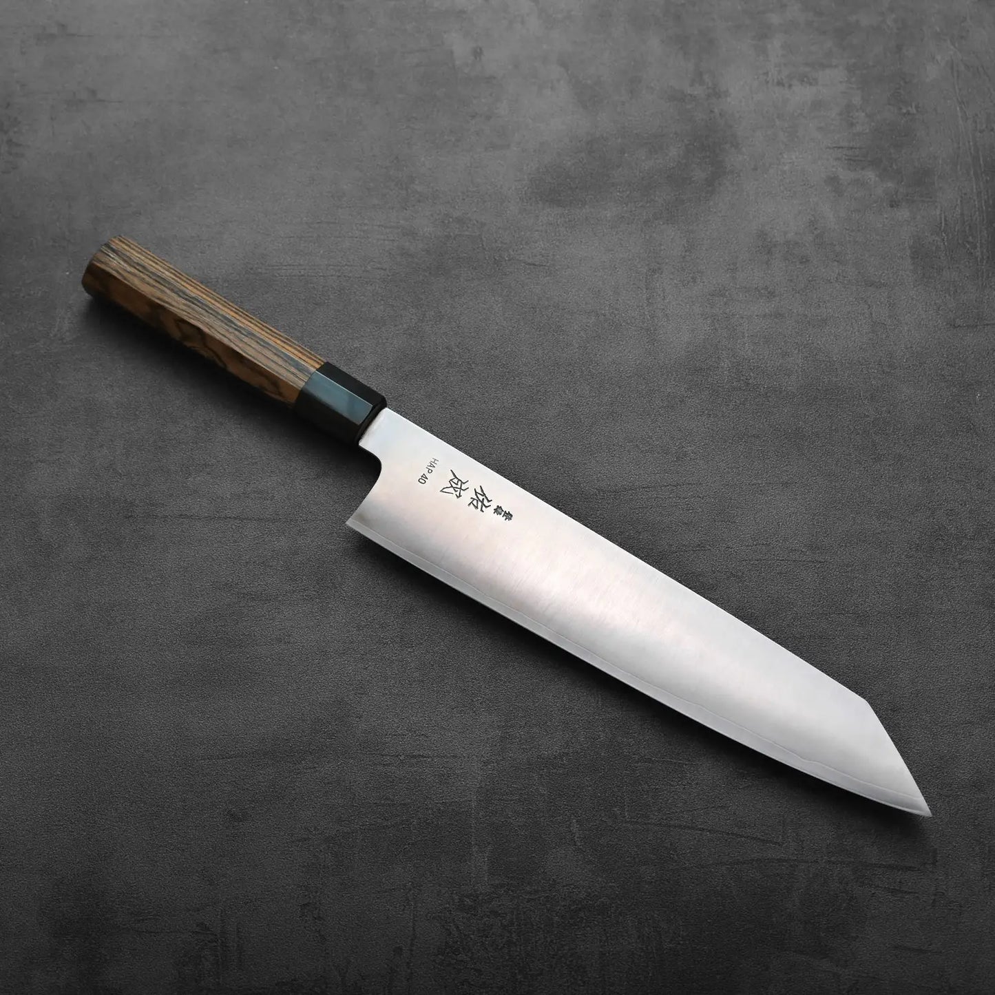 A kiritsuke gyuto with a wooden handle is shown, highlighting the blade length and distinct handle grain.