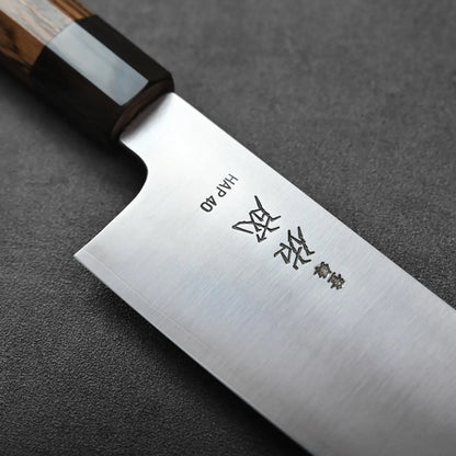 A kiritsuke gyuto with kanji on the blade.