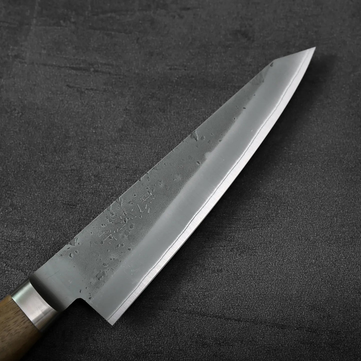 Honesuki knife with a wood handle is displayed, showing the blade and handle clearly.