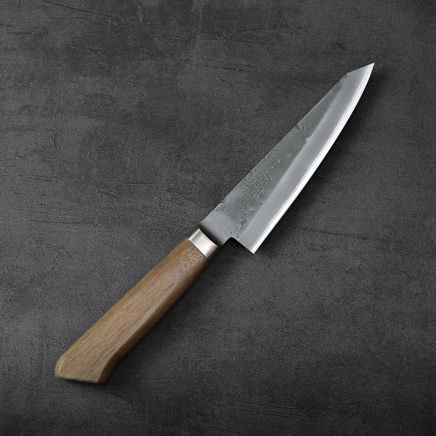 Tadafusa nashiji aogami#2 honesuki 150mm with a wood handle and steel blade, highlighting the distinct lines between materials.