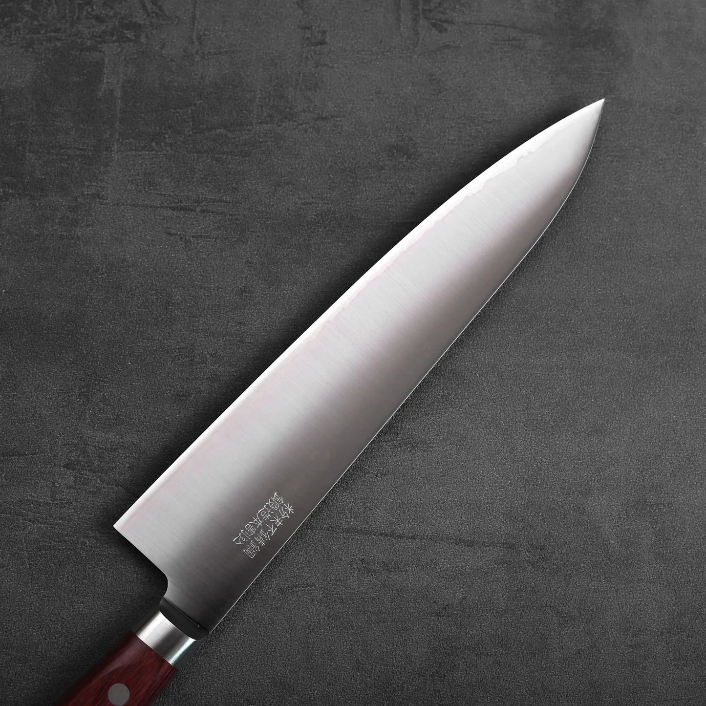A gyuto with a wood handle. The blade features a polished finish and measures approximately 210mm in length.