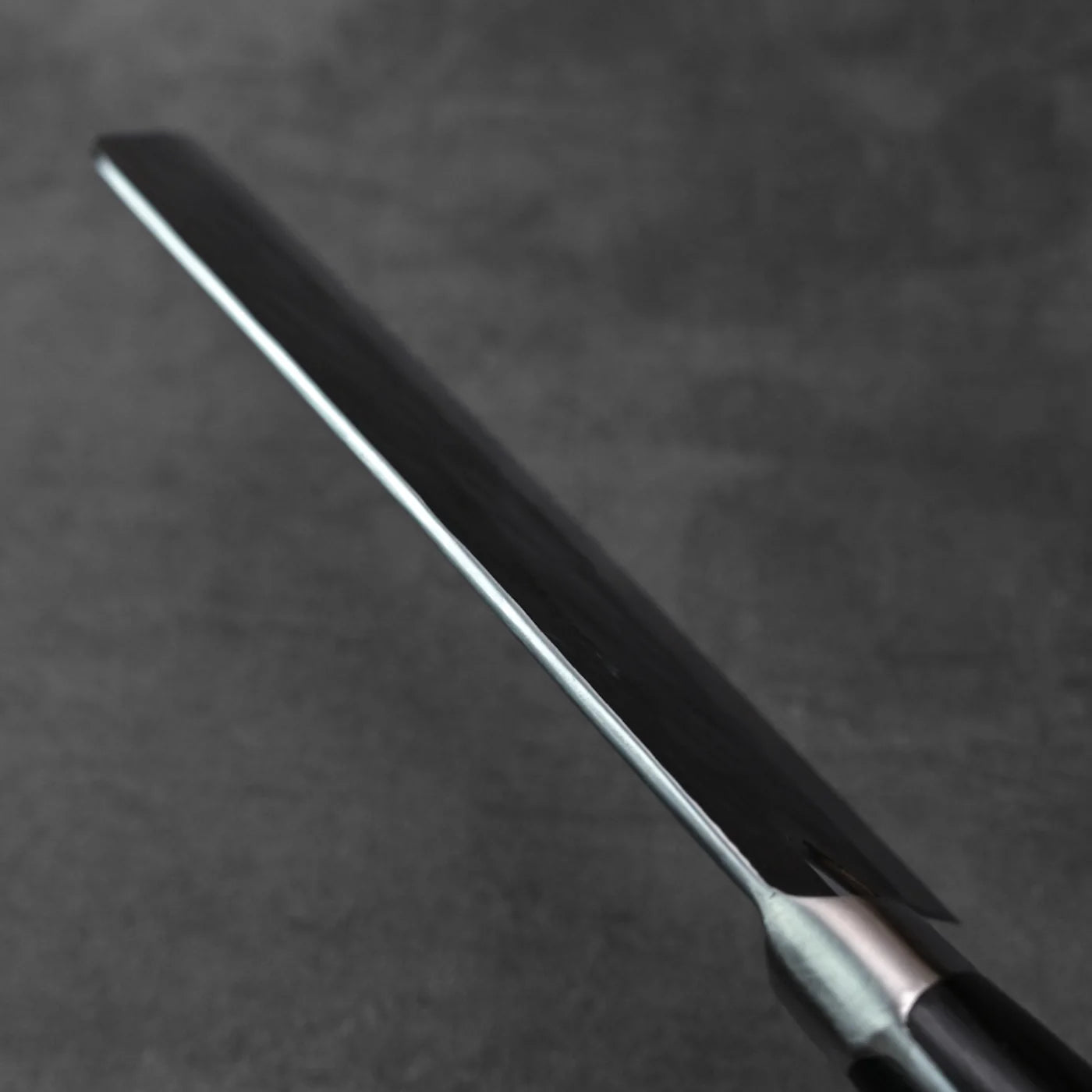Close-up of a bunka blade, showing its tall 175x60mm profile and edge details.