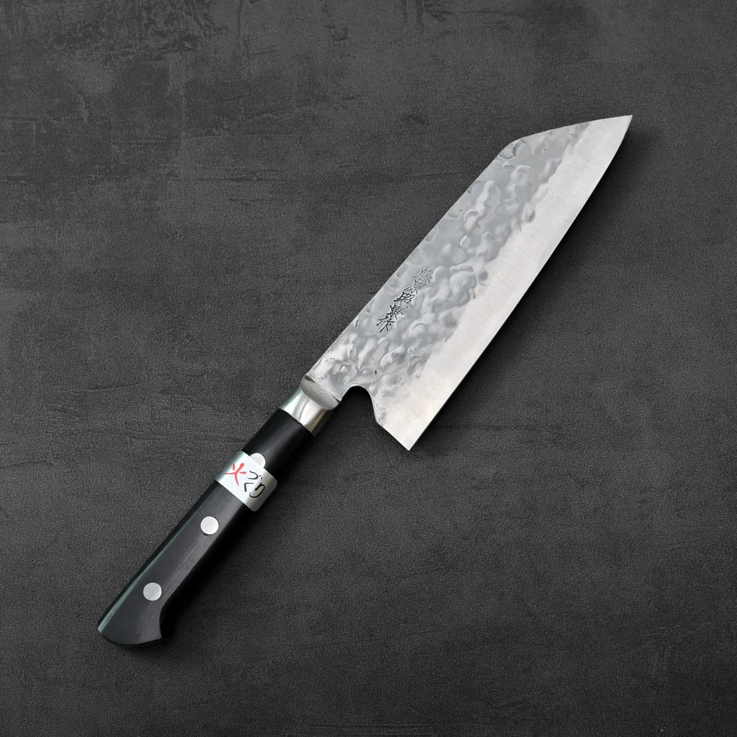 Teruyasu Fujiwara maboroshi santoku 165mm with a hammered blade displayed, highlighting the distinct texture and shape of the metal.