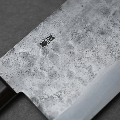 A close-up of the Teruyasu Fujiwara Nashiji Shirogami#1 Chuka Bocho 210x90mm blade, featuring a textured matte finish and engraved kanji, displayed against a dark background.