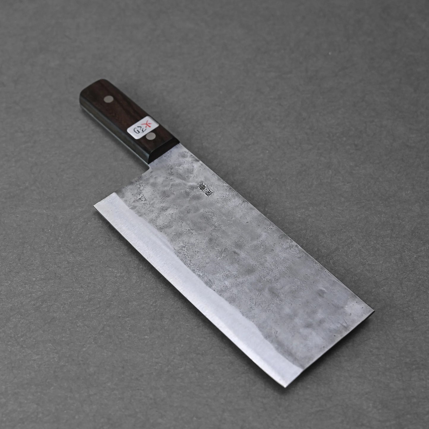 A Teruyasu Fujiwara nashiji shirogami#1 chuka bocho (210x90mm) with a dark wooden handle rests flat on a gray surface, featuring a small white label with red writing near the handle.