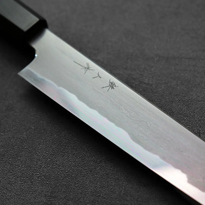 Sujihiki with a dark handle, showing clean lines and detailing along the blade and grip.