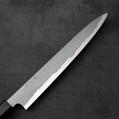 A sujihiki knife with a kasumi finish and 240mm blade is displayed with distinct visual details.