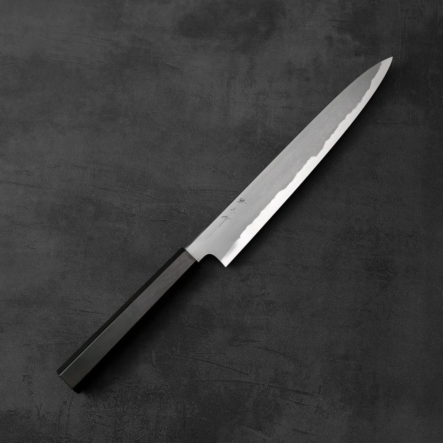 A Tetsujin kasumi aogami#2 sujihiki 240mm with a dark handle is shown, displaying its length and slim profile.