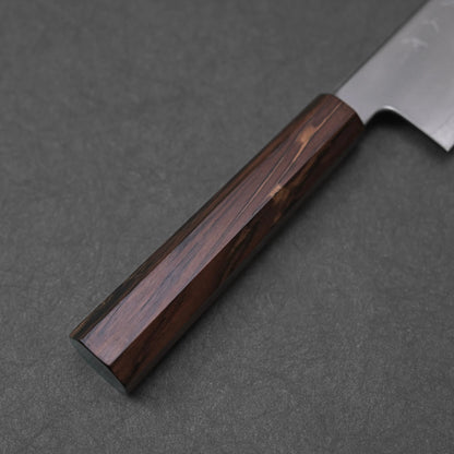 A close-up view of the mono octagonal ebony handle of a gyuto knife. The dark wood exhibits rich, varied brown tones and a visible grain pattern, with the eight facets of its shape clearly defined along its length.