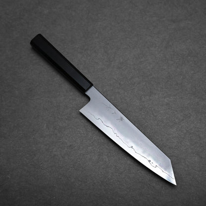 A Japanese-style kiritsuke chef knife with a black handle and a straight-edged blade featuring a distinct wavy pattern, placed on a dark gray textured surface.