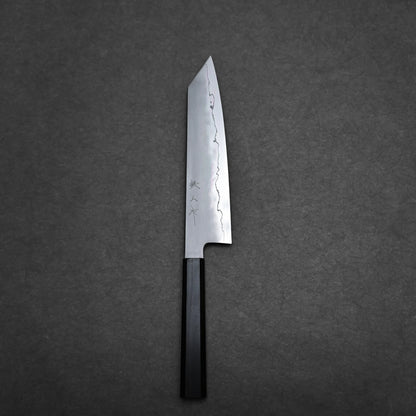 A single kiritsuke Japanese chef knife with a dark handle and a polished, straight-edged blade engraved with Japanese characters, placed on a dark, textured background.