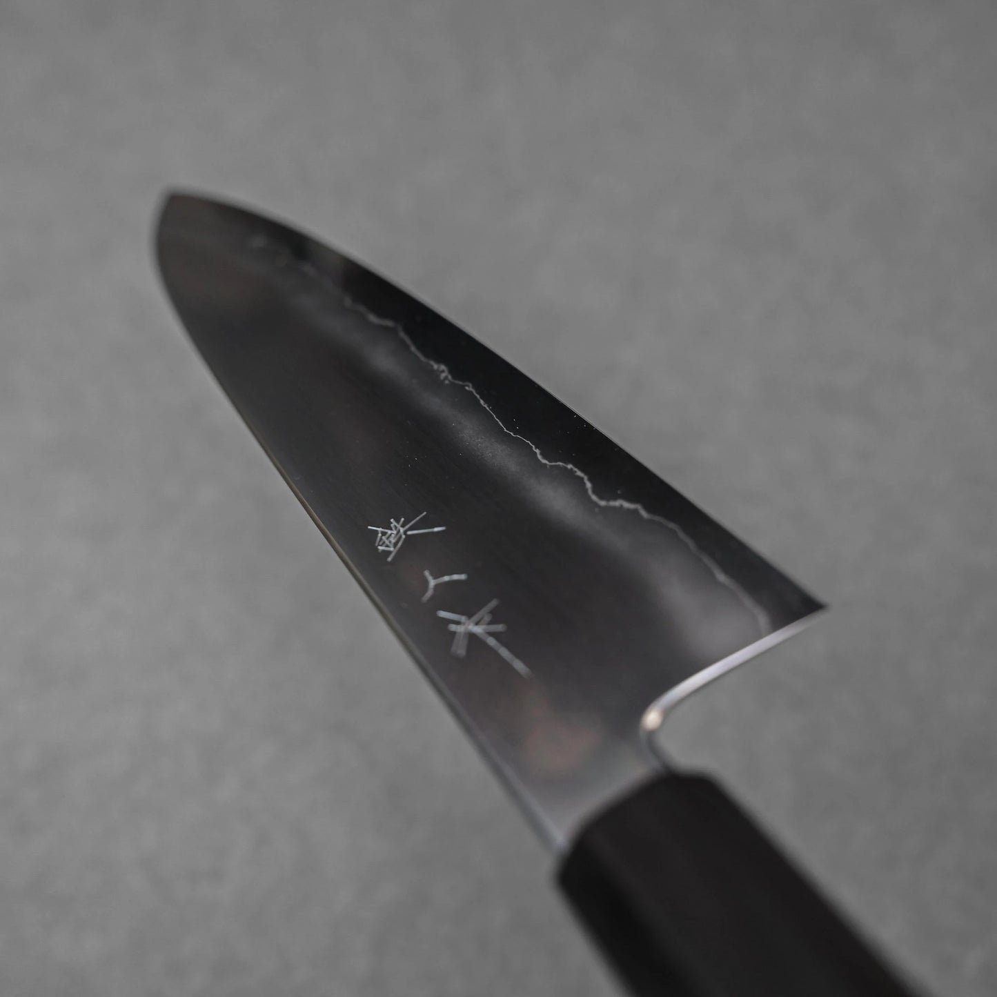 Gyuto knife made with ginsan steel; shown in diagonal orientation to highlight the full blade profile