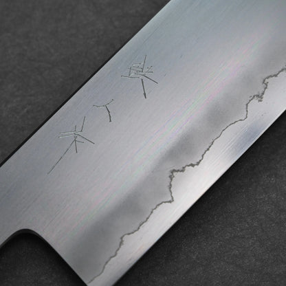 Nakiri knife featuring three vertically engraved kanji characters near the spine; photographed close-up to emphasize the steel surface and engraving clarity.