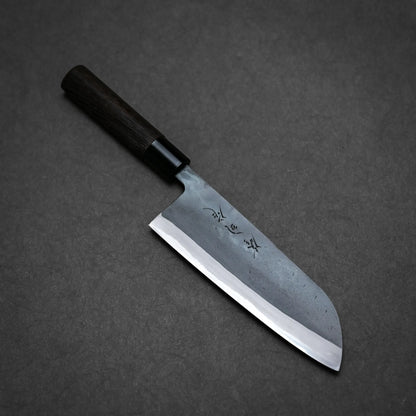 A Kurouchi santoku with a dark wooden handle and a wide, slightly curved blade featuring engraved characters, displayed on a dark grey background. This Japanese-style all-purpose knife embodies traditional craftsmanship.