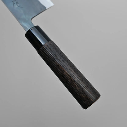 Close-up of a Sanjo santoku kitchen knife featuring a dark wooden handle and a partial view of the shiny metal blade against a plain gray background.