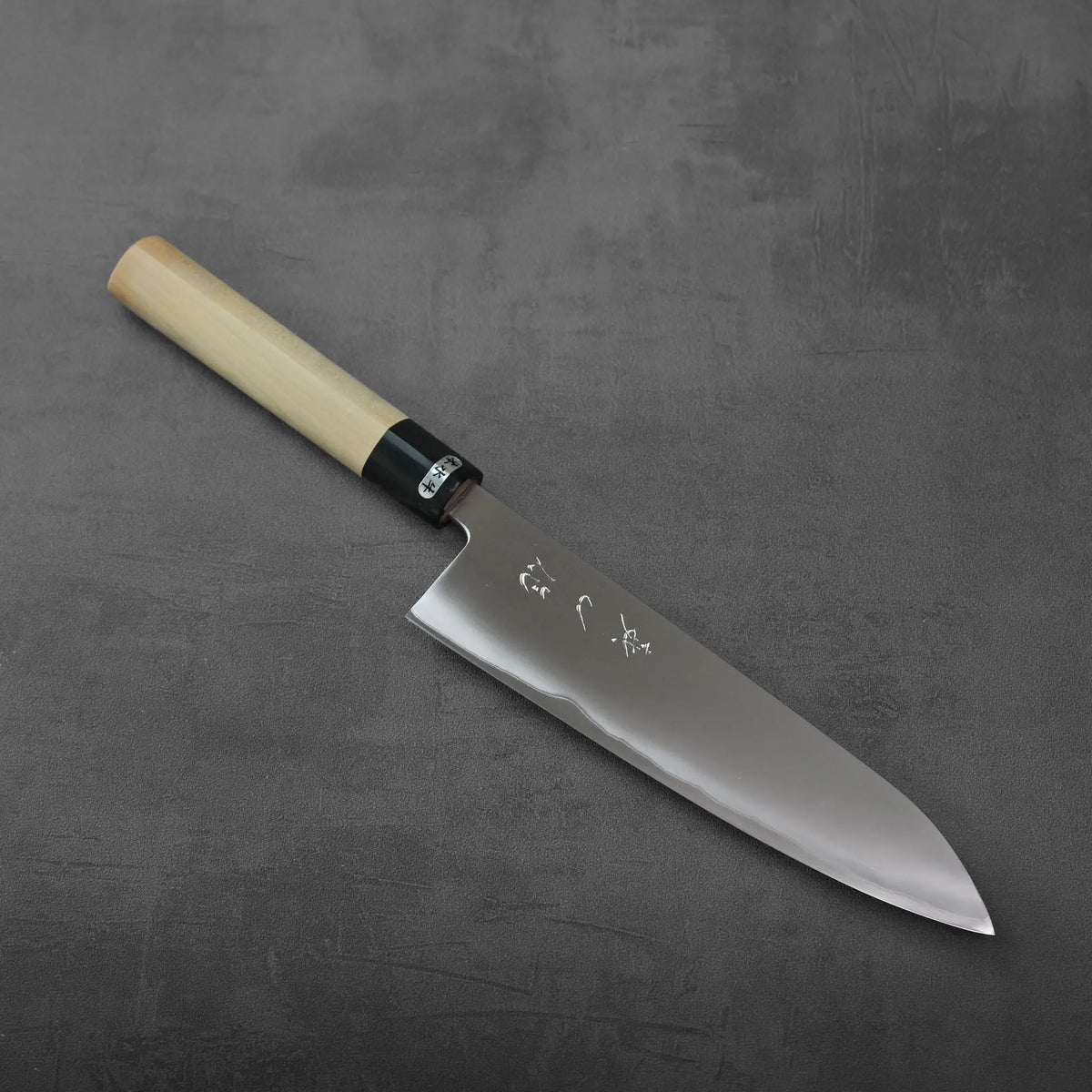 Gyuto with a wooden handle and black ferrule.