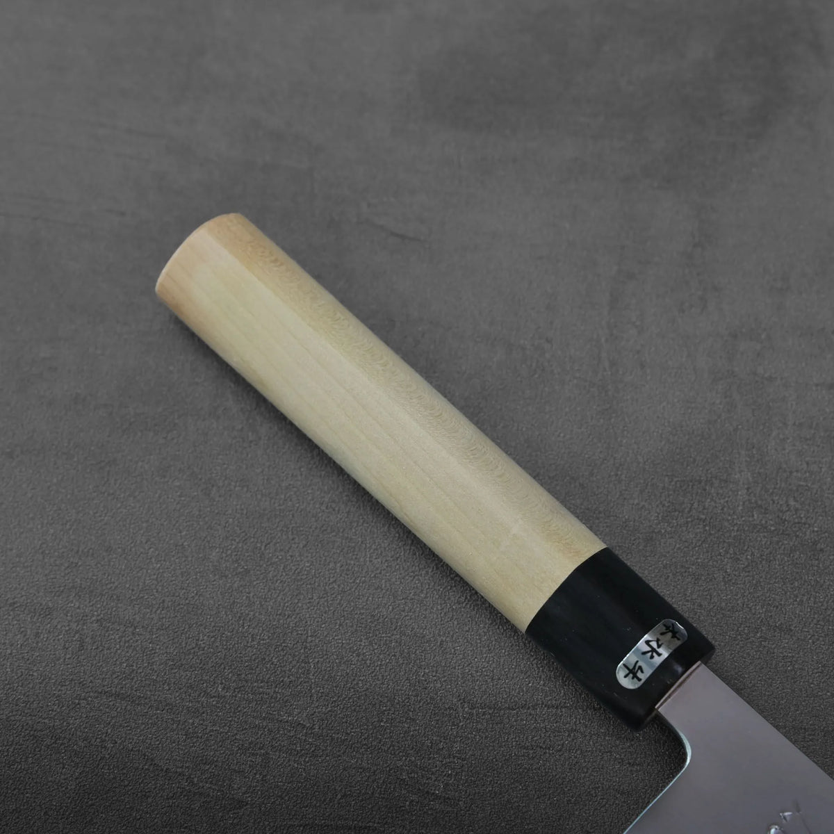 Gyuto with a light-colored wooden handle and a black ferrule with Japanese characters.