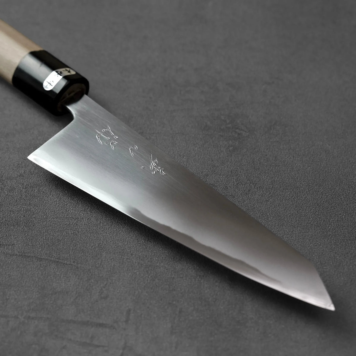 Honesuki 150mm knife with a pointed blade and a wooden handle featuring a black collar.