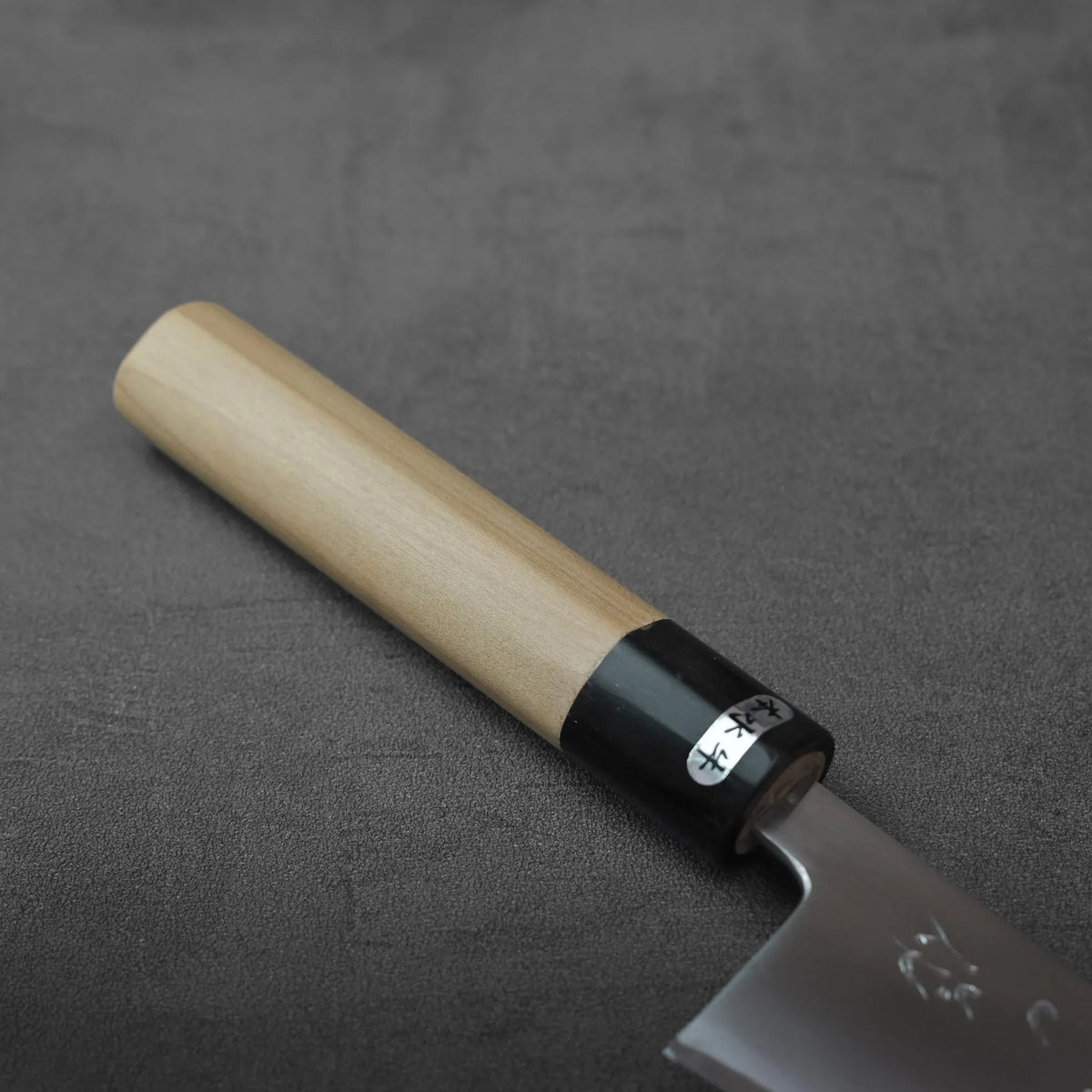 Honesuki 150mm with a light wood cylindrical handle and a black ferrule featuring characters.