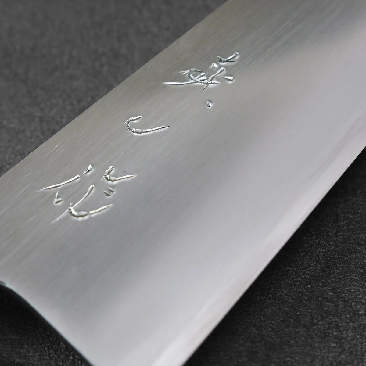 Honesuki 150mm blade with engraved Japanese characters.