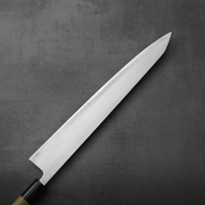 Sujihiki with a long, narrow blade and a dark wood handle with a light ferrule.
