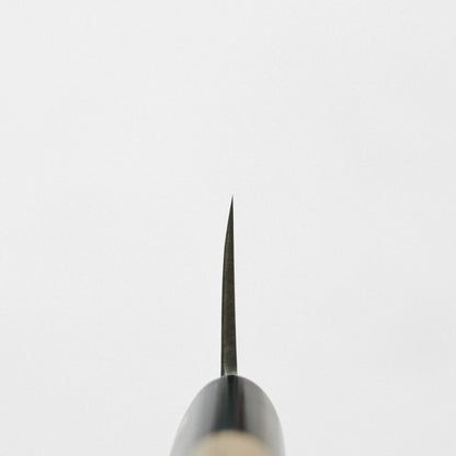 Spine view of a honesuki, showing the thin blade and a cylindrical wood handle.