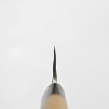 End-on view of a sujihiki 270mm blade tip showing the beveled edge and rounded wooden handle.
