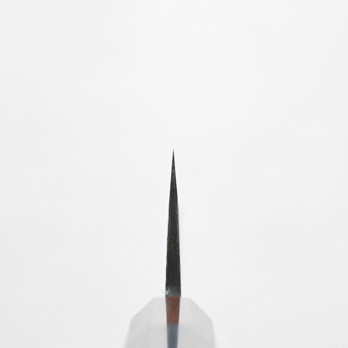 Choil shot of a gyuto, 240x55mm, positioned tip upward 