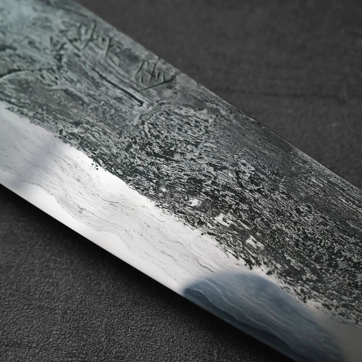 Close-up of gyuto with Damascus steel blade, 240x55mm, intricate pattern visible on the blade.