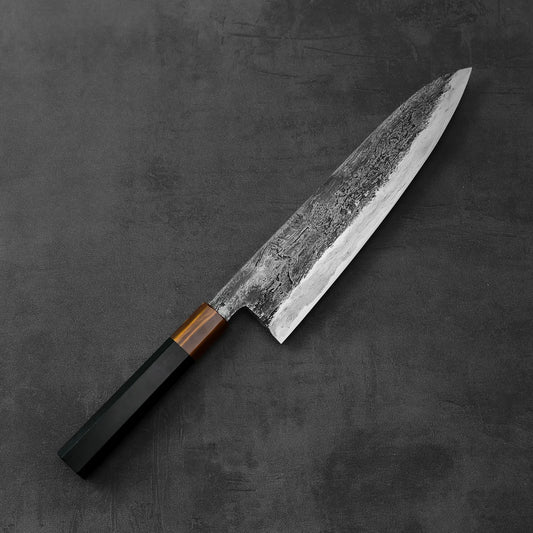 A Yamada rentetsu aogami#1 tall gyuto with dark handle and wrought iron-clad textured blade, measuring 240x55mm.