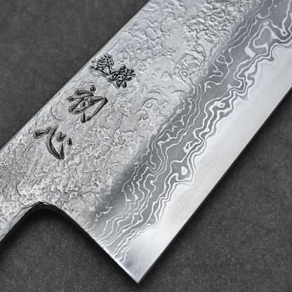 Close-up of the Yoshihide Masuda aogami#1 damascus santoku 180mm blade, featuring a striking Damascus finish and engraved Japanese characters, showcasing its layered metal texture against a dark background.