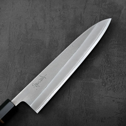 A gyuto with a burnt chestnut handle featuring nashiji finish and shirogami#2 steel.