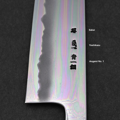 Close-up of a Japanese kitchen knife blade with kanji engravings, temper line, and subtle rainbow reflection. Featured on the right: Yoshikazu Tanaka Aogami#1 Tall Gyuto 230x54mm.