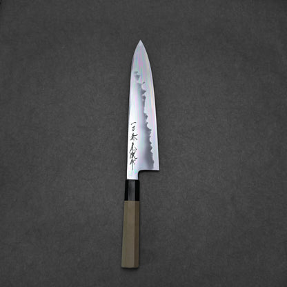 A Japanese chef’s knife with a wooden handle and patterned blade featuring Japanese characters, displayed on a dark gray textured background.
