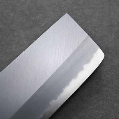 Close-up of a Tanaka AS nakiri blade with a straight edge, visible hamon line, and a slightly angled tip, set against a dark gray textured background.