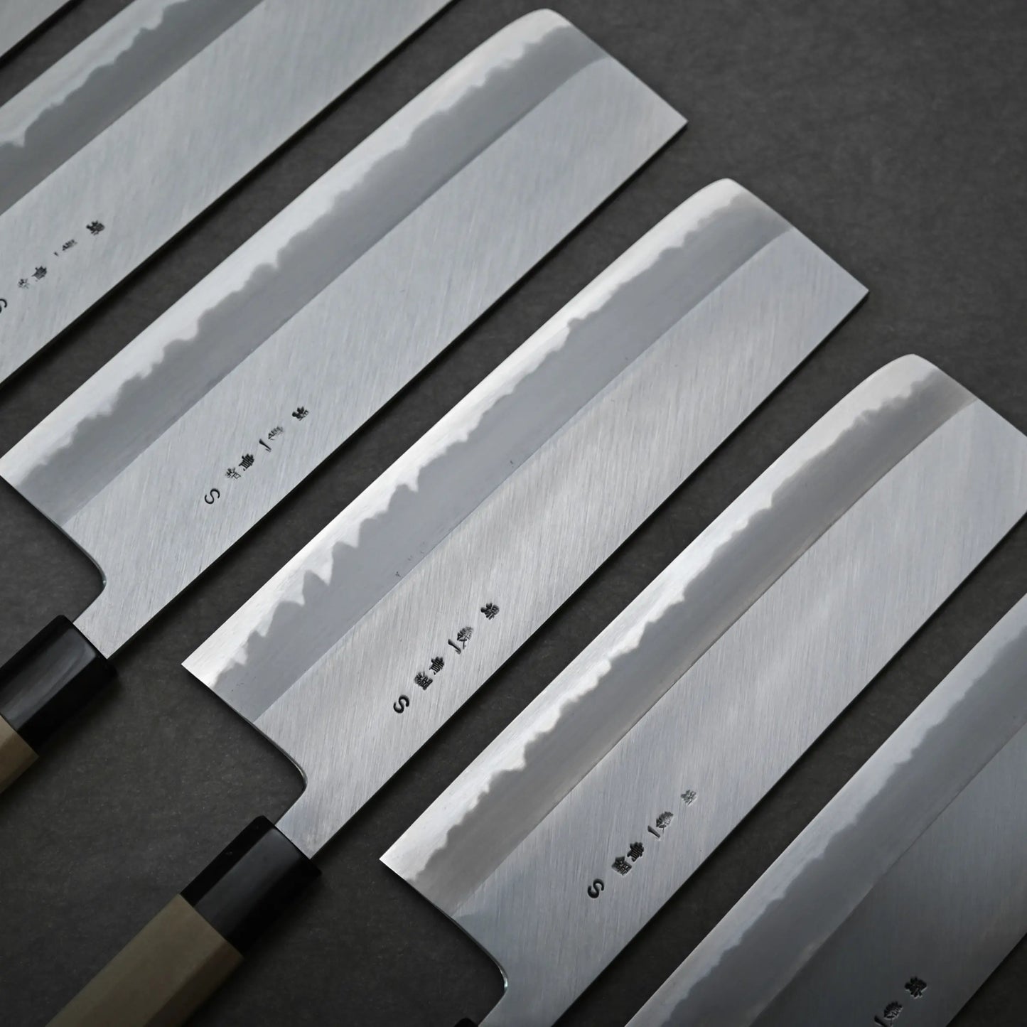 Set of four nakiri knives with engraved kanjis on the back side