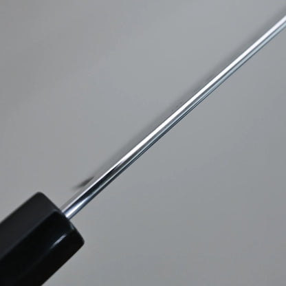 A close-up view of the spine of Tanaka AS nakiri, shown against a plain, out-of-focus background.