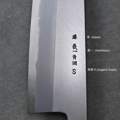 Close-up of a Tanaka AS gyuto blade with engraved kanji characters and the letter S, along with English translations—Sakai, Yoshikazu, and Aogami Super—set against a dark textured background.